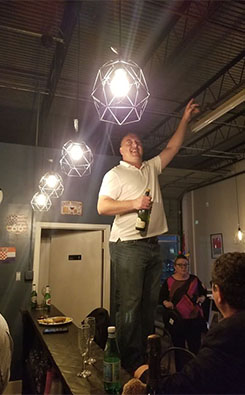 Igor trying to open a champagne bottle