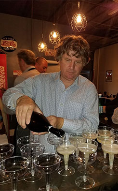 Mladen filling champagne into glasses